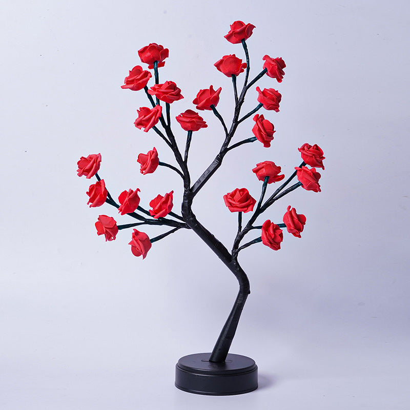 Rosenträdslampa med rosa rosor som lyser